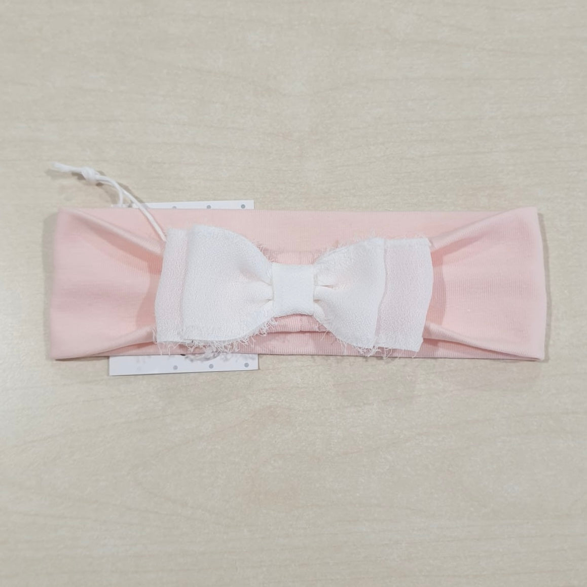 Fascia rosa in cotone con fiocco bianco ricamato